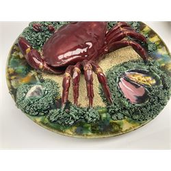 Two 20th Century Portuguese Palissy style Majolica wall plates, one depicting a crab, the other a lobster each to the centre modelled in relief surrounded by encrustations and shells, both with impress marks beneath, D34cm