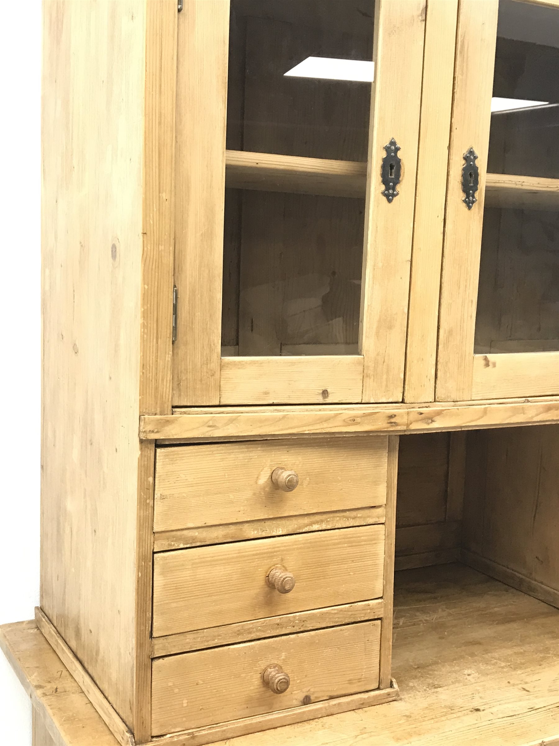 Early 20th century pine kitchen cupboard, raised glazed cabinets with drawers, lower section fitted with two drawers and panelled double cupboard, turned feet,  W127cm, H195cm, D62cm