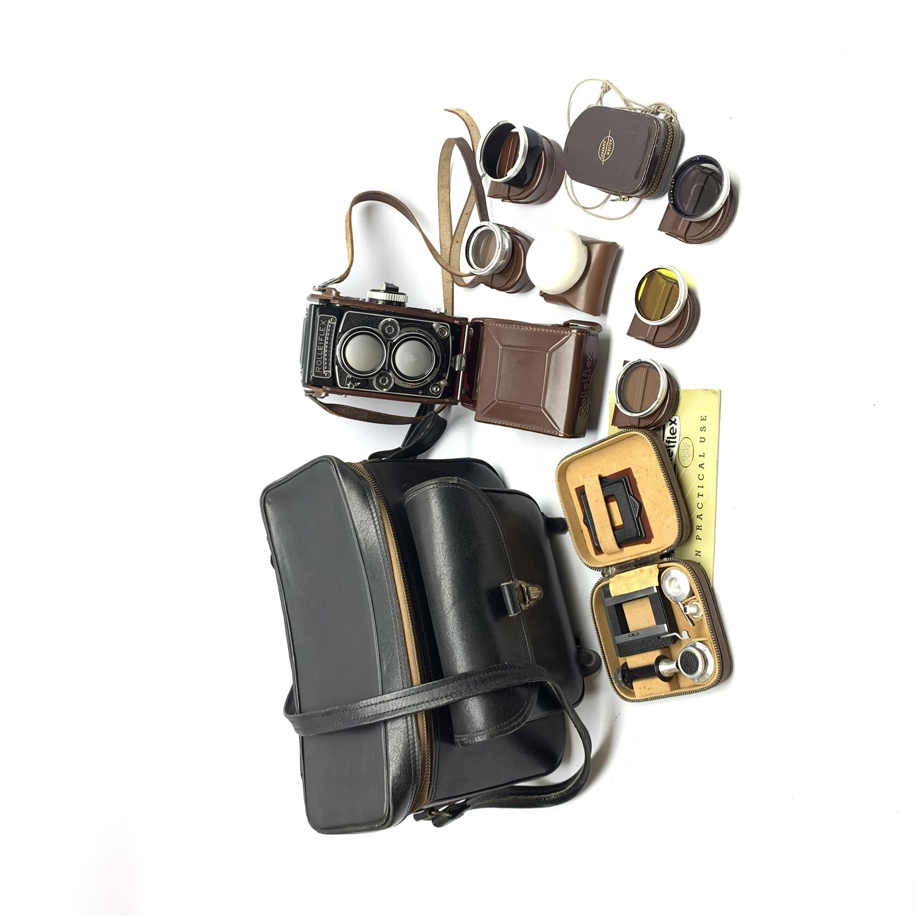 Rolleiflex 2.8F camera in leather case together with; 'In Practical Use' instruction manual, Rolleipol -1.5 lens in case, Rollei Rolleiflex lens hood Bay III in case, Rollei Gelb Mittel -1.5 filter in case, Rollei R1 -0 lens in case, Heidosmat-Rolleinar 1 with Rolleinar 1, Weston Master IV light meter and Weston Master IV Invercone in cases, Rollei Rolleiflex Rolleikin in case, hand grip with Rolleifix plat, all in carry case