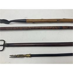 Two late 19th century fruit picker canes, the first example a French ebonised bamboo cane, with pair of fruit scissors to base, the handle stamped Cueille Fruit, the second example with grabbing action, the cap stamped A C Harris, Leicester, together with two other 19th century canes, one with fork and the other with hoe
