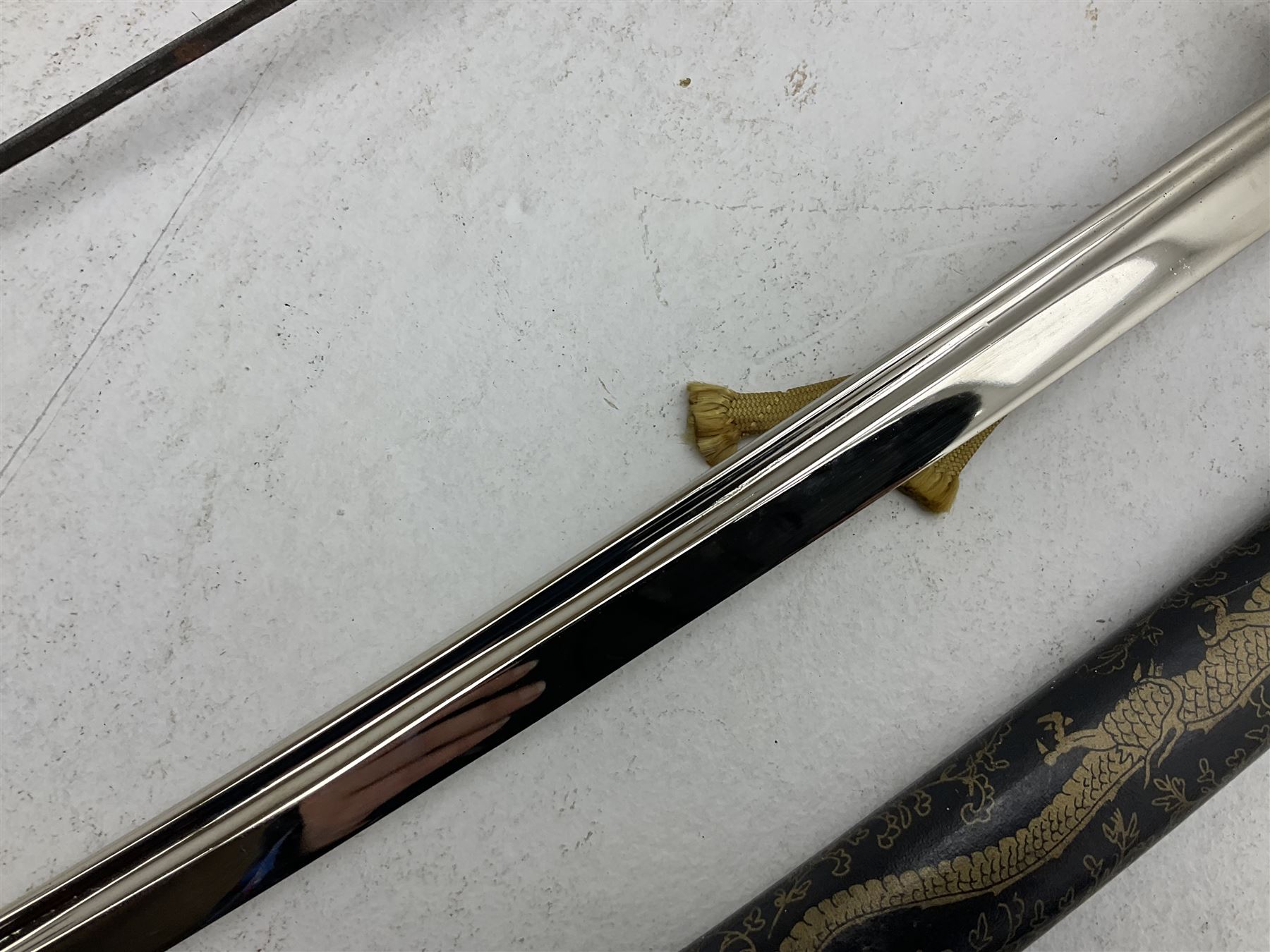 Reproduction Japanese katana with 63cm slightly curving fullered steel blade, ornate tsuba, cord bound grip and gilt transferred black saya L92cm; and two fencing foils, one marked Leon Paul (3)