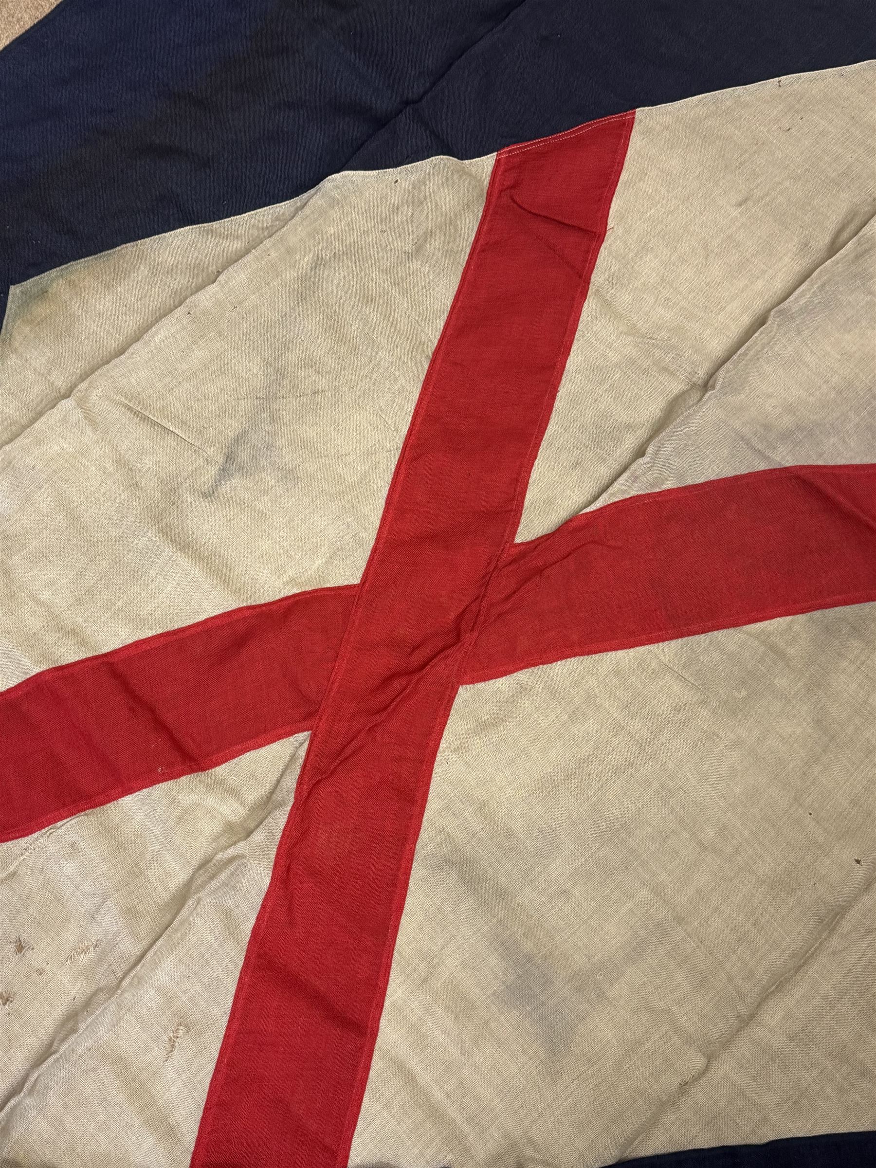Ship's house flag, rectangular linen flag, with a white diamond and red cross to the centre, upon a cobalt blue ground, inscribed on the hoist 'Cutty Sark', H130cm, W170cm

Provenance by vendor repute: Vendor's father was a naval cadet in 1940s/50s on board HMS Worcester which was moored alongside the Cutty Sark on the River Thames at Greenhithe. He has had the flag since then. 