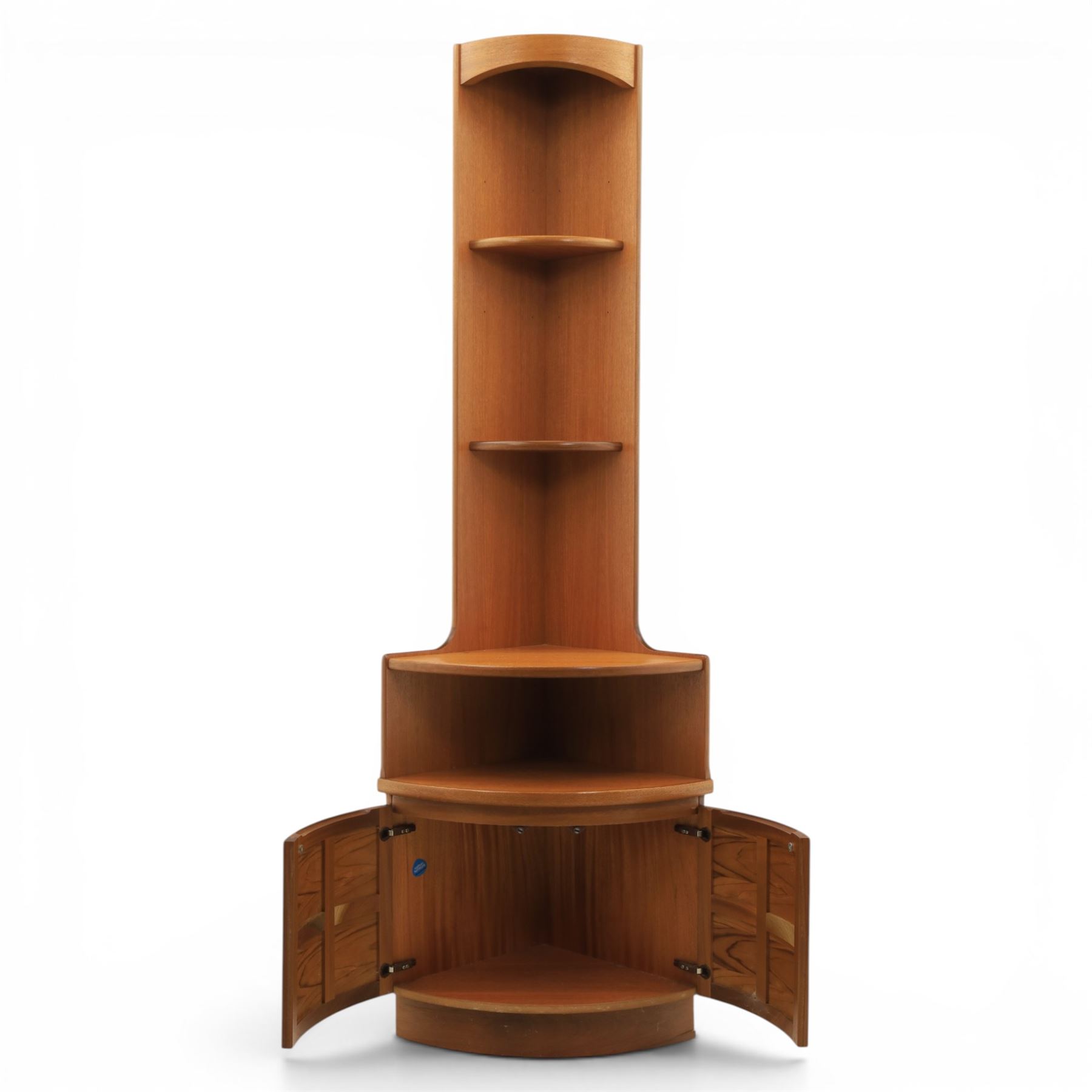 Nathan - teak corner cabinet, the upper section with moulded cornice and two fixed shaped open shelves, above a curved corner cupboard with twin signature square panelled doors, on a shaped plinth