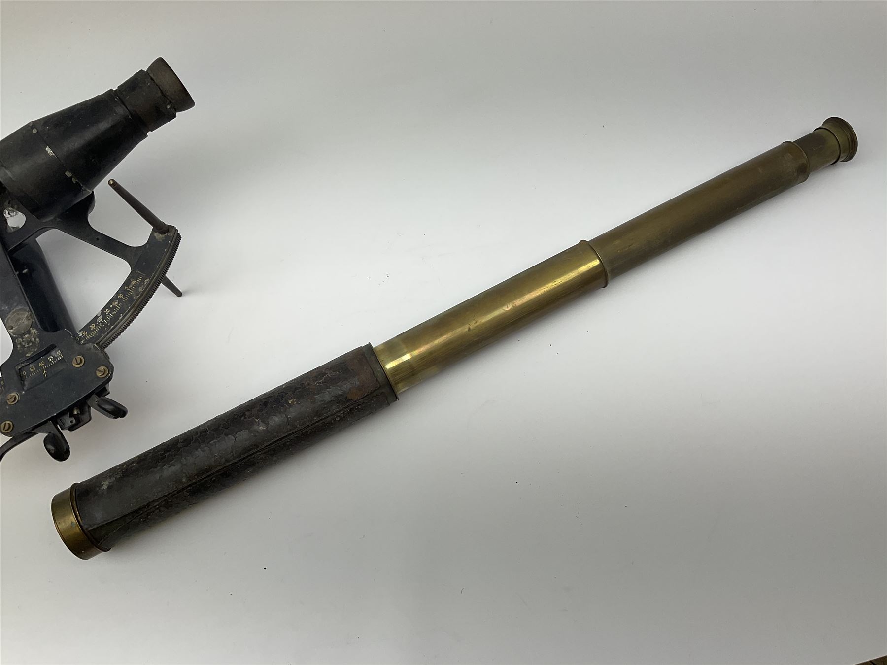 Henry Hughes & Son 'Husun' black finished brass sextant marked H (broad arrow) O No.287 W29cm; and a 19th century Harris & Son London brass three-draw telescope with leather covered tube L72cm extended (2)