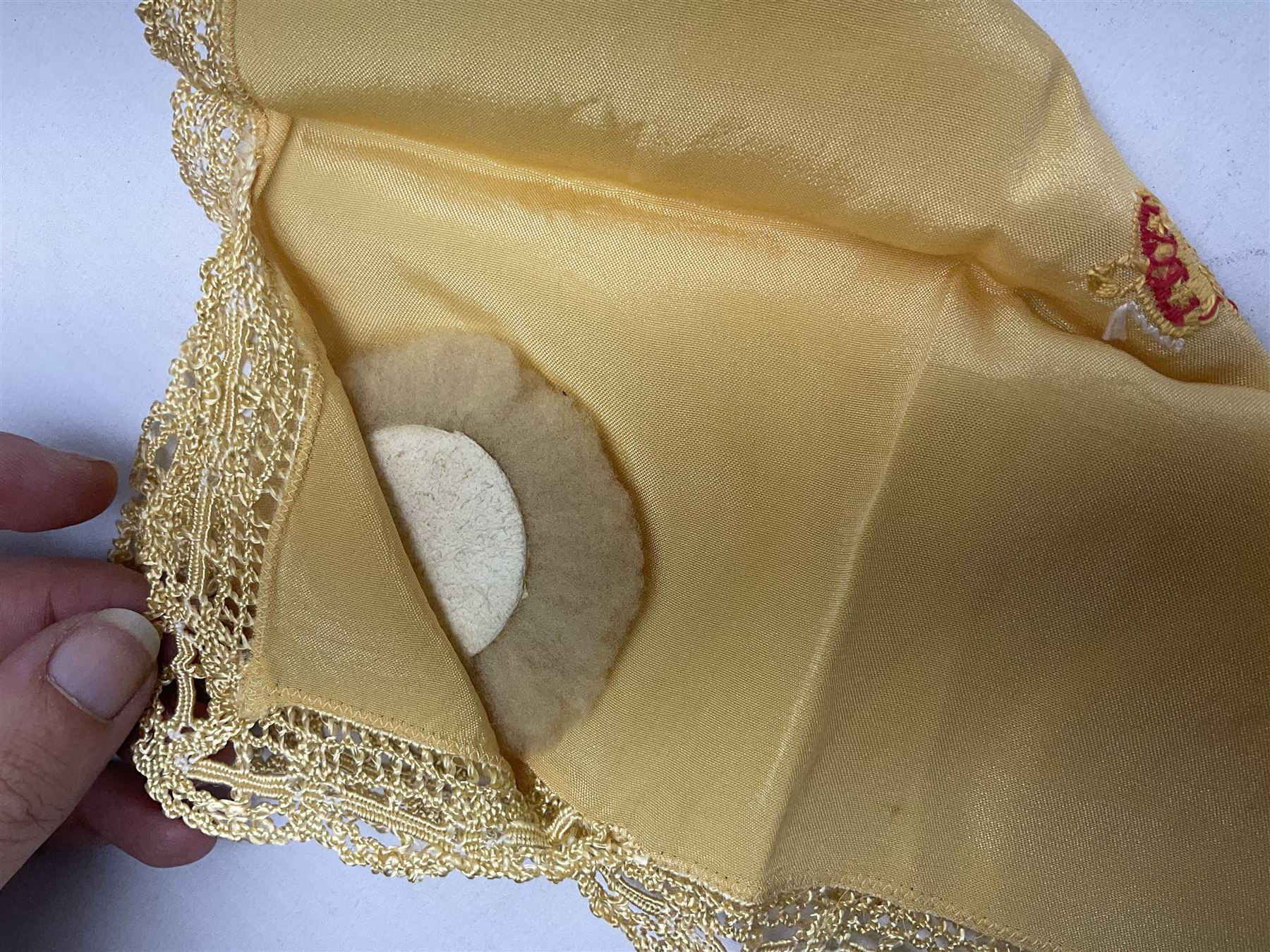 Three WW1 embroidered silk handkerchiefs including RAF & RN; trench art brass napkin ring inscribed 'Arras' and miniature peaked cap with inset 1914 penny; small quantity of cap badges and pips; four reference books on medals and badges etc