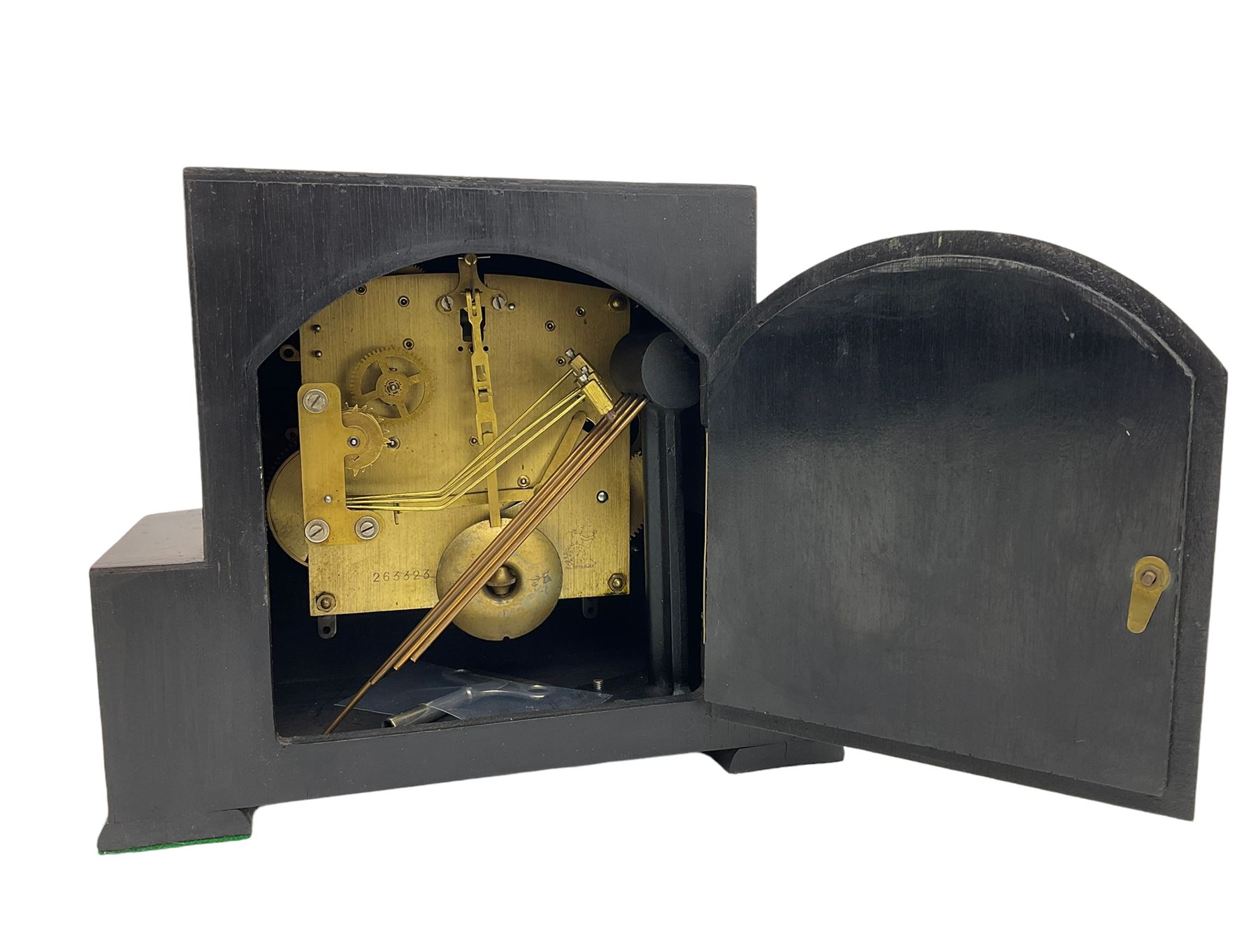  A  1930s “Bentima” Westminster chiming English art deco mantle clock in a stylised mahogany case with a square dial, chrome Arabic numerals and corresponding pierced hands within a chrome bezel, three train Perivale movement chiming the quarters on 4 gong rods, strike/silent facility. With pendulum and key. H24 



