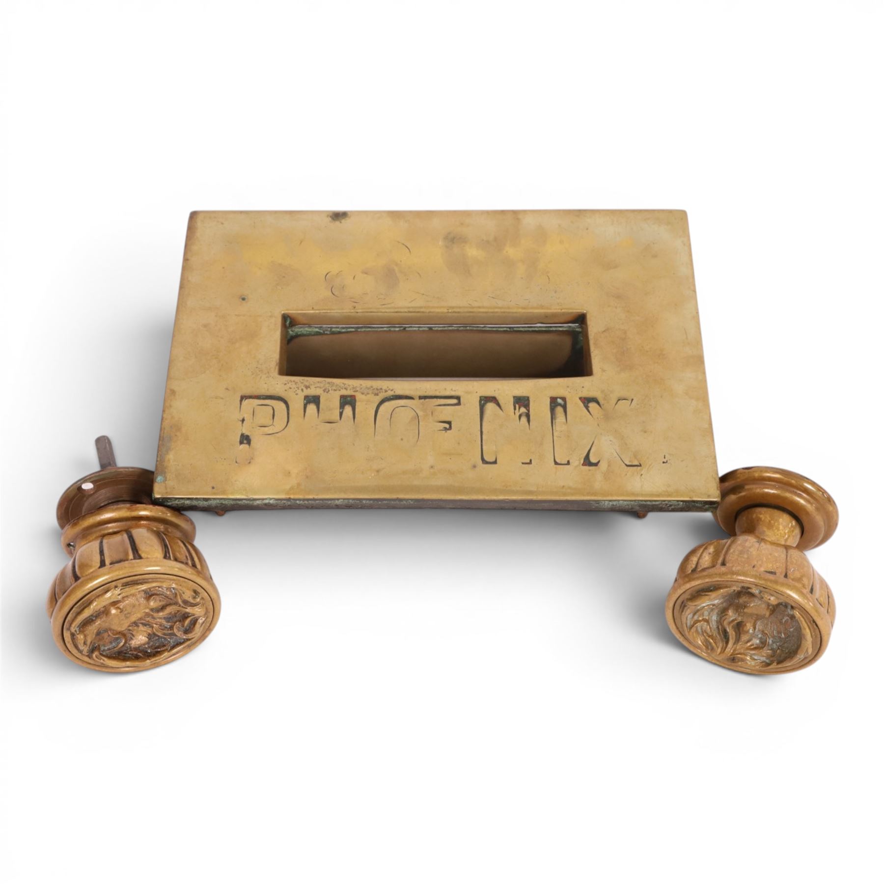 Late 19th century brass door knob set and brass letter box cover for Phoenix Assurance Company Limited, the door knobs each cast with fluted sides, the fronts with deep cast phoenix, square spindle shaft, each approximately L7.5cm, the letter box cover inscribed Phoenix beneath rectangular letter recess and flap, 19cm x 28cm