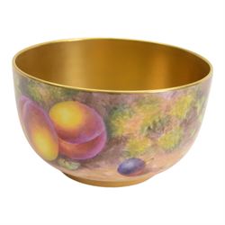 20th century Royal Worcester footed bowl, hand painted with gilt interior, the exterior a still life of fruit upon a mossy ground, signed Freeman, with black printed mark beneath, together with plate side plate and cabinet plate, bowl, H8cm, D13cm