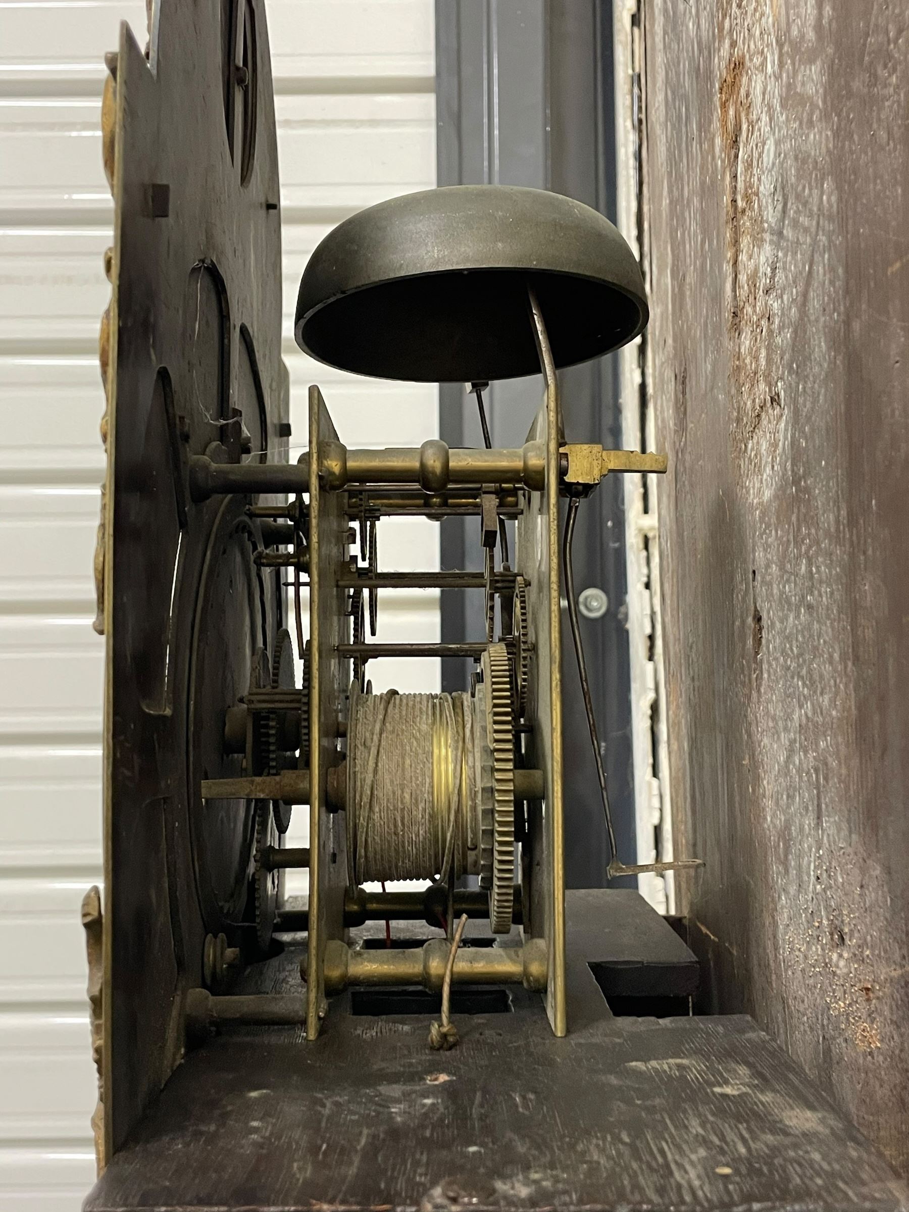 Gilbert Kidd of Malton (North Yorkshire) - late 18th century oak 8-day longcase clock c1780,  with a tall double caddy top and later brass ball and spire finials, break arch hood door beneath with attached pilasters and wooden capitals,  plain trunk with a long flat topped door, raised on a square plinth with applied skirting,  brass break arch dial with the makers name to the silvered boss in the break arch, engraved and silvered dial centre and chapter ring, with cast spandrels and matching steel hands, subsidiary seconds dial and square calendar aperture, dial pinned directly to a rack striking movement with a recoil anchor escapement, sounding the hours on a cast bell. With pendulum and weights.
The Kidd family were a prolific family of provincial clockmakers working in Malton from the mid 18th century until the early 19th century. Many of their clocks are simply signed 