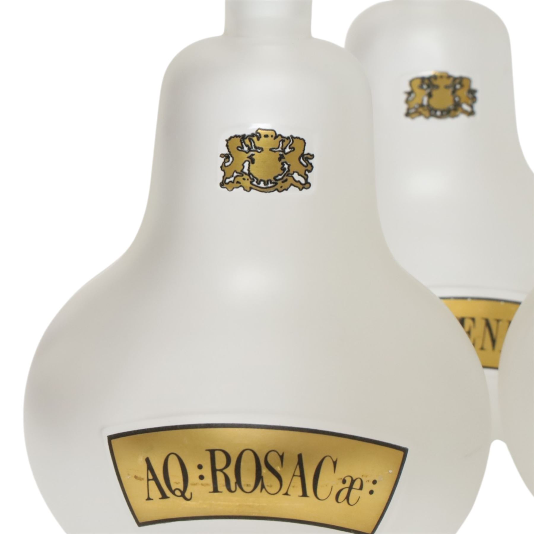 Set of four 20th century Royal Pharmaceutical Society white frosted glass bottles, of bellied form with clear cut glass spire stopper, each body bearing gilt label in Latin: AQ:CINNAM:, AQ:FOENIC:, AQ:HAMAM:, and AQ:ROSACae:, and gilt Royal Pharmaceutical Society crest to neck, H25cm

Provenance: From the collection of the family of Peter Green, a practising pharmacist whose career spanned the mid to late 20th century. During his professional life he managed pharmacies in Yeovil, Somerset, and later Selles Chemist in Filey, North Yorkshire, before purchasing and running his own business, Peter Green Pharmacy, located in the Market Place, Malton. The bottles were displayed as part of the traditional shop fittings in both the Filey and Malton pharmacies and were retained as part of his collection.