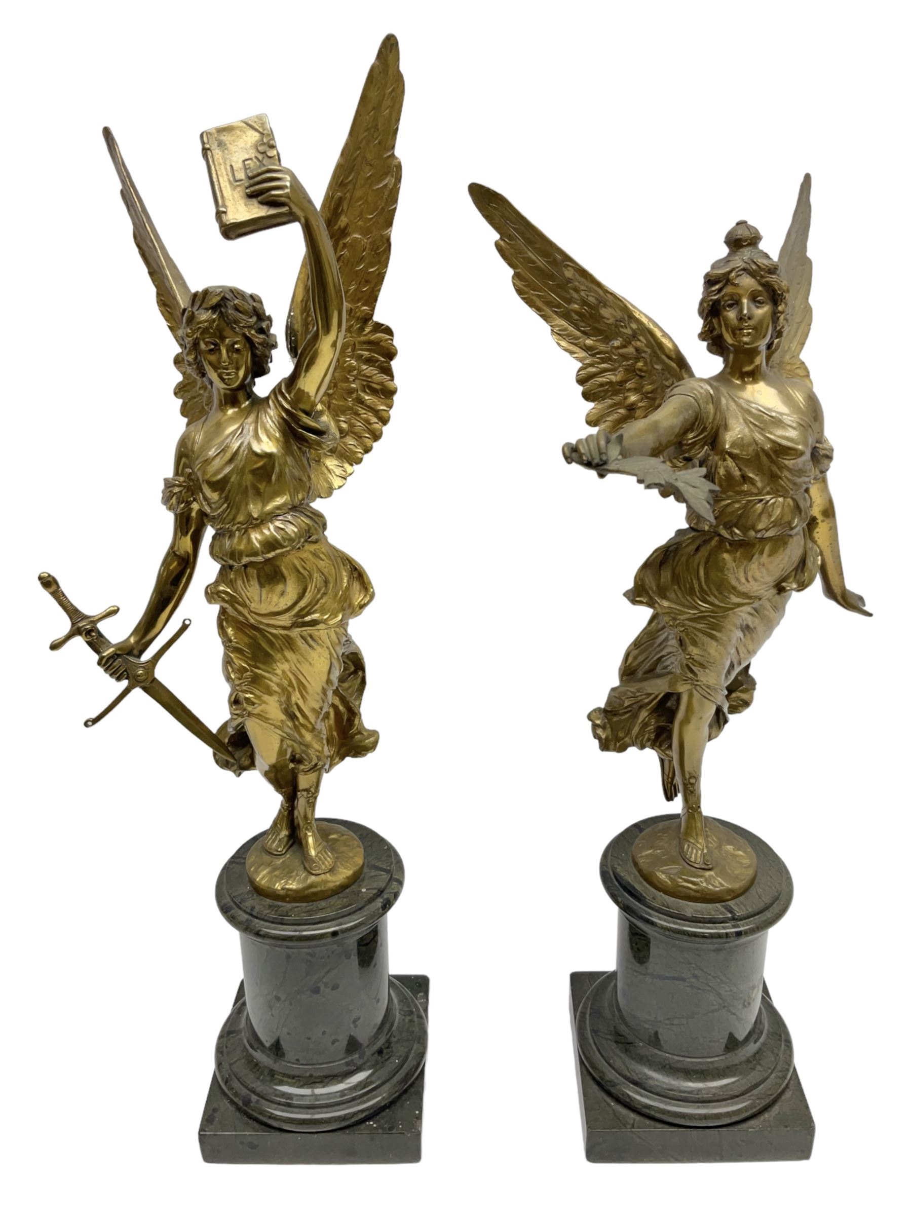 After Oswald Schimmelpfennig (German, 1872-1939): Pair of gilt bronze winged Allegorical female figures, the first example with arm outstretched holding a branch, signed 'Schimmelpfennig 1900', the second with arm raised above her head holding a book and sword in the other, both raised upon marble plinths, H45cm