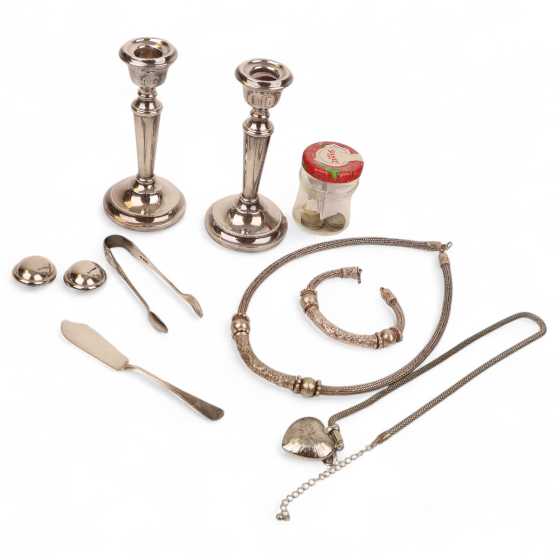 Pair of weighted silver candlesticks, silver tongs, silver knife, silver threepence coins, silver and costume jewellery