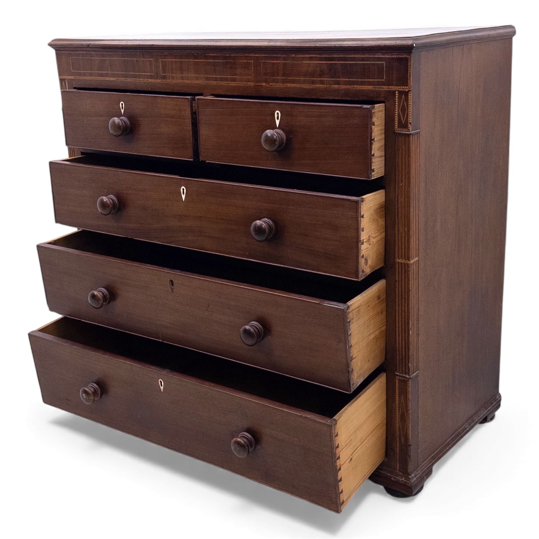 Early 19th century mahogany chest of drawers, the rectangular top with boxwood line inlay above two short and three long graduating drawers, each with turned wooden knobs and bone escutcheons, flanked by fluted uprights with diamond inlaid panels, on shaped bracket feet