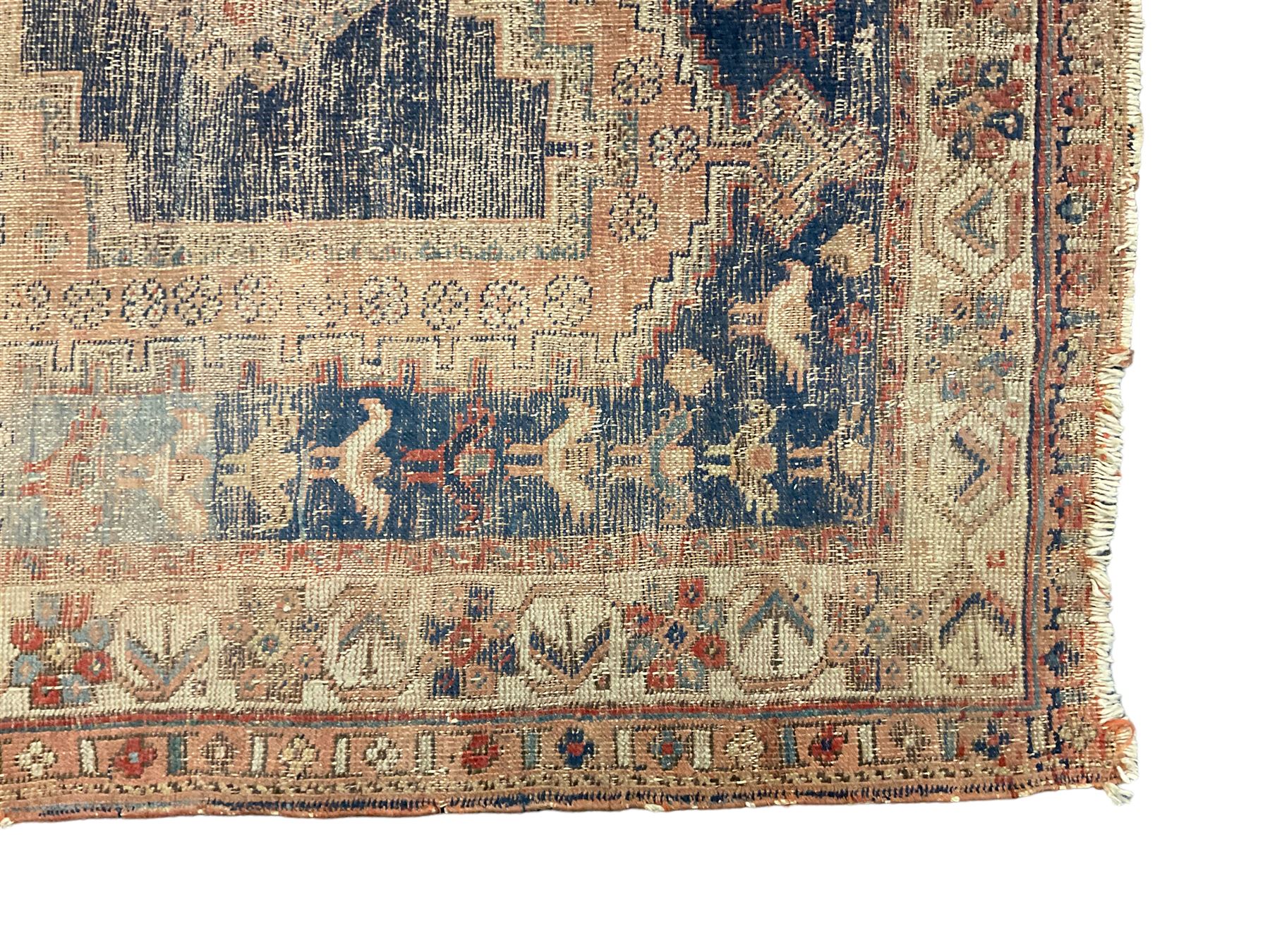 Antique Caucasian rug, indigo ground field decorated with three lozenge medallions within borders of stylised bird and flower head motifs