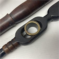 Two late 19th century fruit picker canes, the first example a French ebonised bamboo cane, with pair of fruit scissors to base, the handle stamped Cueille Fruit, the second example with grabbing action, the cap stamped A C Harris, Leicester, together with two other 19th century canes, one with fork and the other with hoe