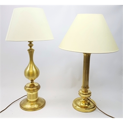  Two large gilt metal table lamps, each with accompanying cream fabric shade, largest H77cm high.   