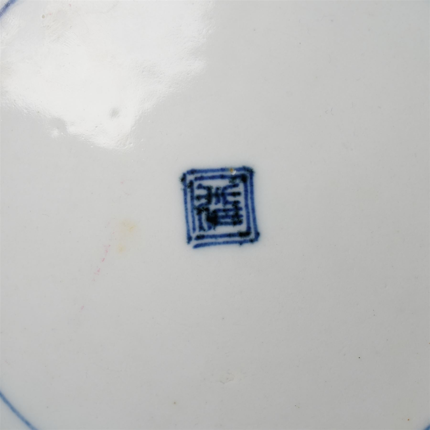 Pair of Japanese Edo period Ko Kutani dishes, decorated in green, yellow, blue iron-red, and aubergine enamels, the centres painted with a singing bird perched on a rock among foliage, within a border of alternating geometric designs and a chocolate-brown rim, the reverse with underglaze blue foliage, Fuku mark, D20.8cm (2) A matching pair of dishes is held in the collection of the Cleveland Museum of Art (see accession no. 1964.262)