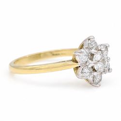 18ct gold diamond flower head cluster ring, principal round cut diamond of approx 0.55 carat, surrounded by six round brilliant cut diamonds, hallmarked, total diamond weight 1.15 carat