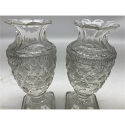 Pair of early 19th century heavy cut glass vases, the bodies of urn form with hobnail and strawberry decoration and flared petal shaped rim raised upon stepped canted square bases with cut eight-point stars, H17.5cm