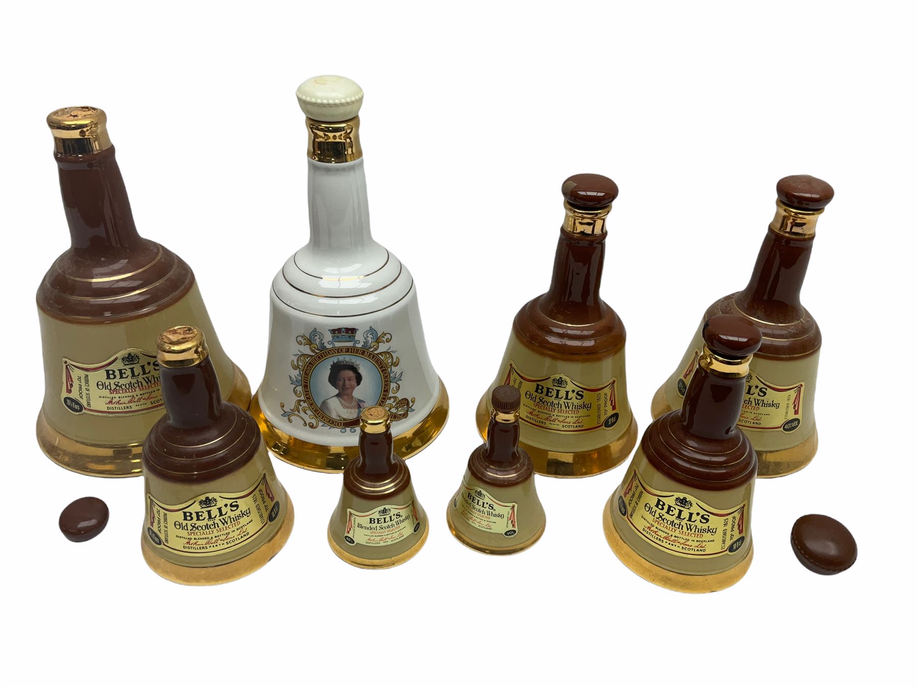 Seven Bell's Whiskey Wade ceramic bell decanters, of various sizes