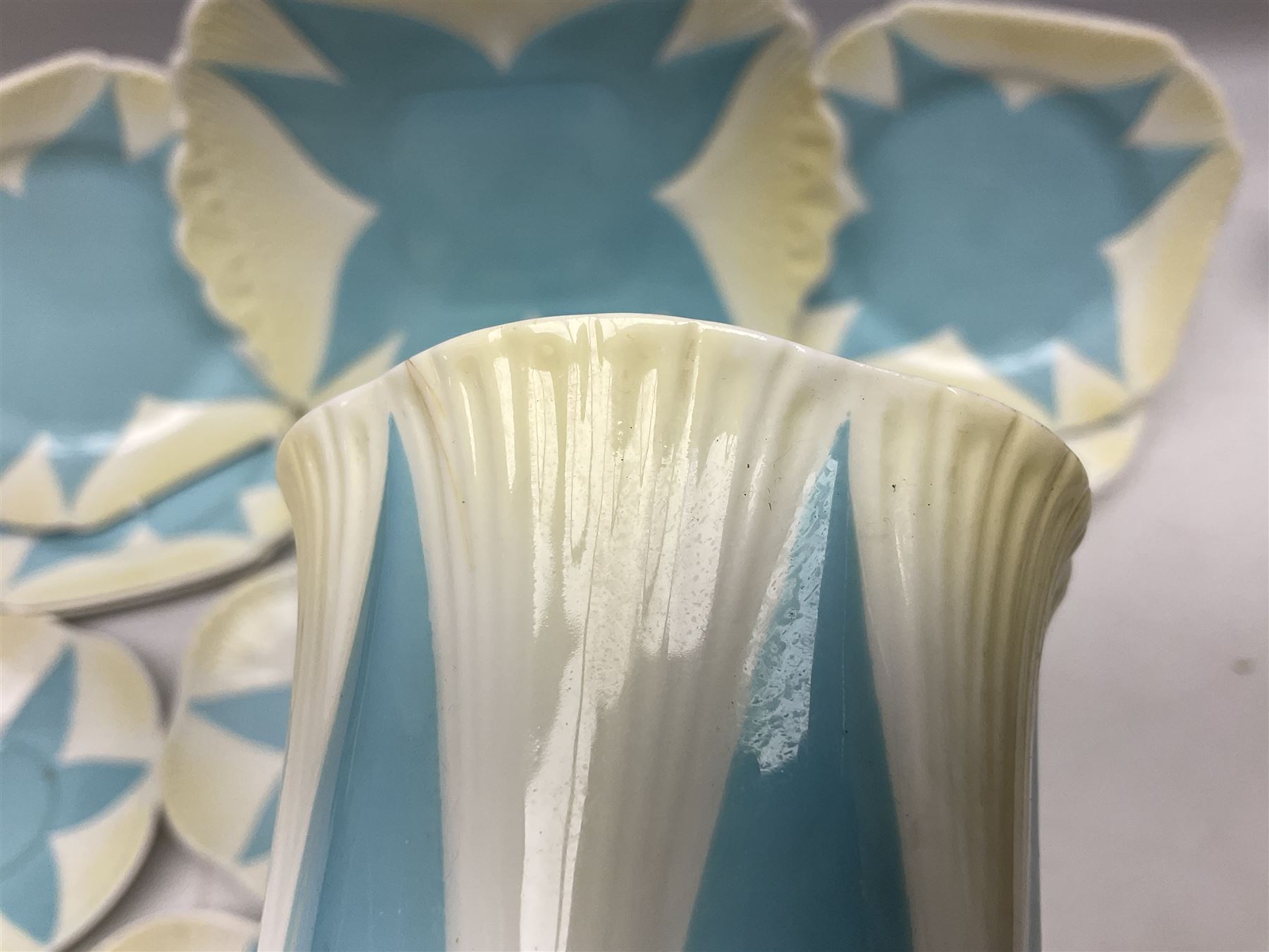 Shelley Dainty pattern tea wares, of lobed form with blue star decoration on merging white and yellow ground, comprising five teacups, five saucers, six tea plates, milk jug and cake plate, all with printed green mark beneath, some with painted pattern no 11770