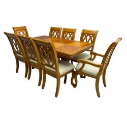 Yew wood extending twin pedestal dining table, rectangular top with ebony stringing over turned and reeded vasiform pedestals on tripod bases, with two additional leaves (W159cm D92cm); and set of eight (6+2) matching dining chairs, high pierced backs over seats upholstered in ivory fabric, on cabriole supports (W57cm H101cm)