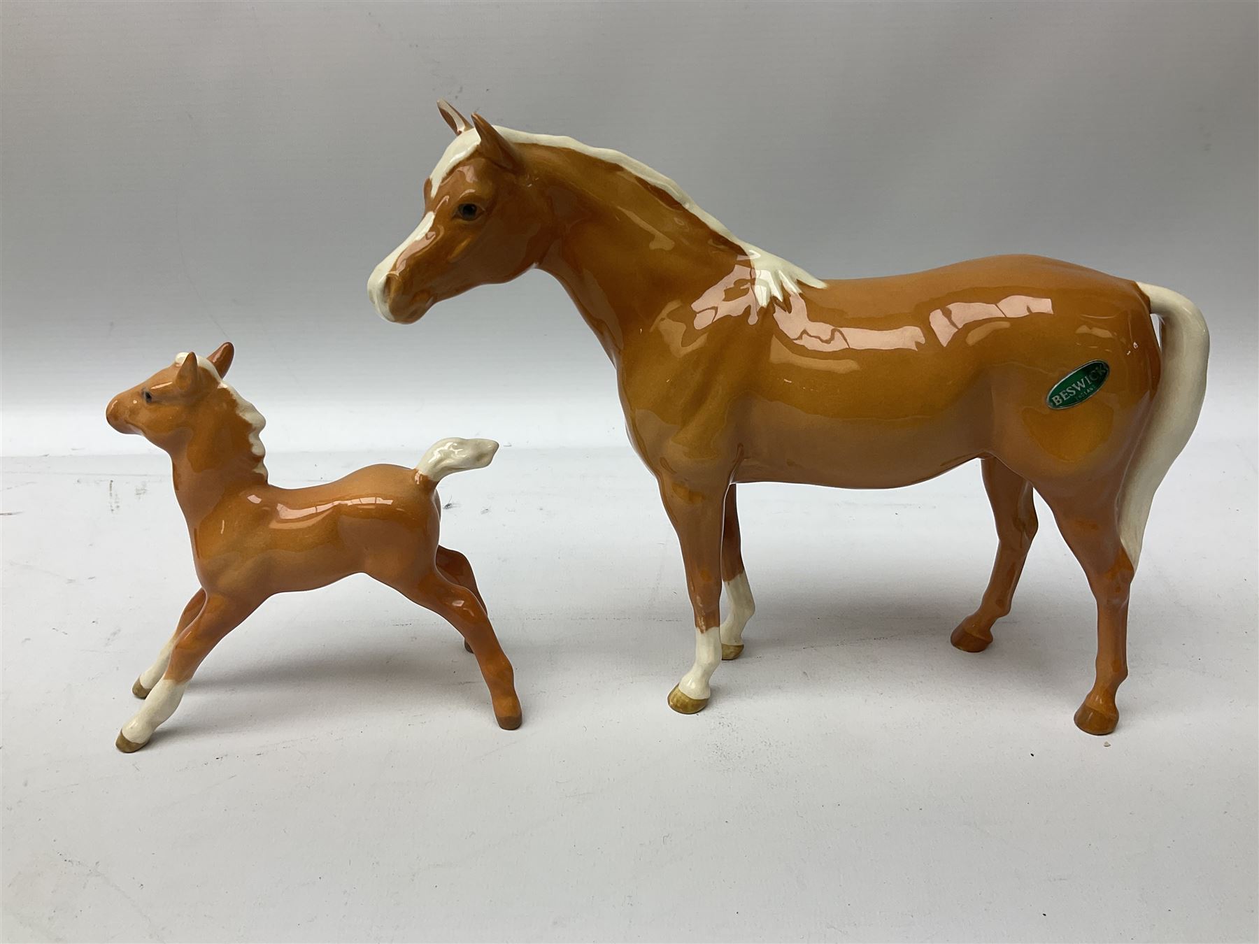 Collection of Beswick horses, including grey horse no.701, palomino foal no 836, grey stocky jogging mare no.855 etc, together two Royal Doulton horses, (8)