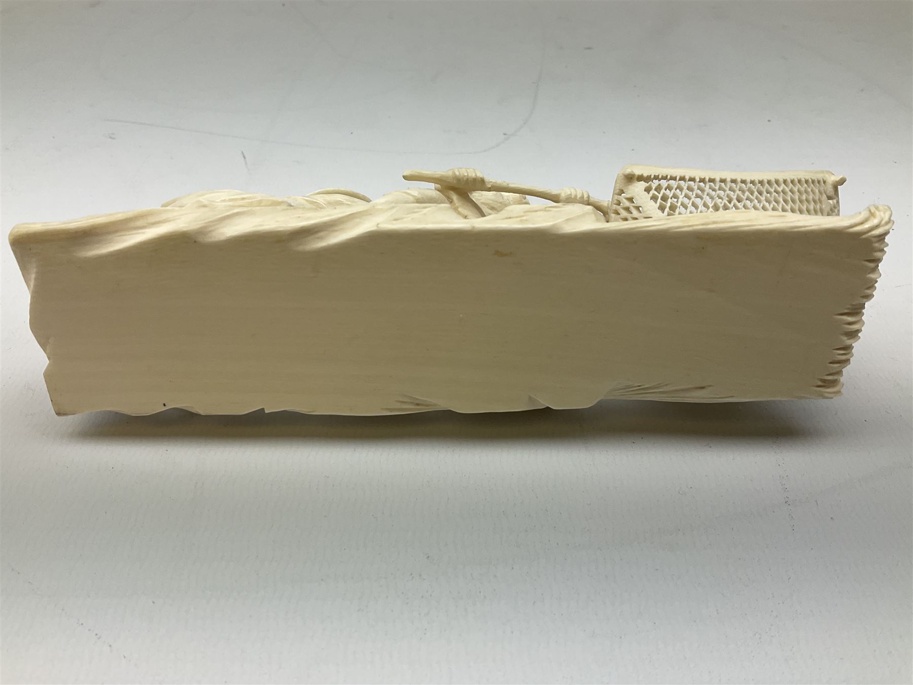 Japanese Tokyo School one piece ivory okimono, 19th century, carved as two fisherman with a net, H6cm, L15.5cm