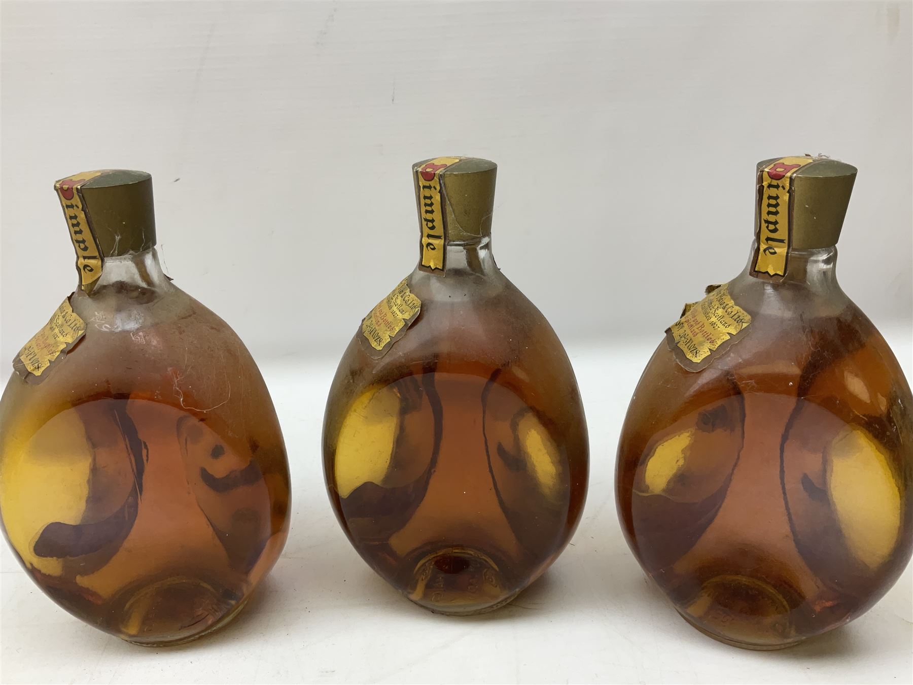 Four bottles of Haig's Dimple Old Blended Scotch whisky, all 26 2/3 Fl.OZs, 70 proof, one in original box and a bottle of East India 1961, Madeira, unknown contents and proof