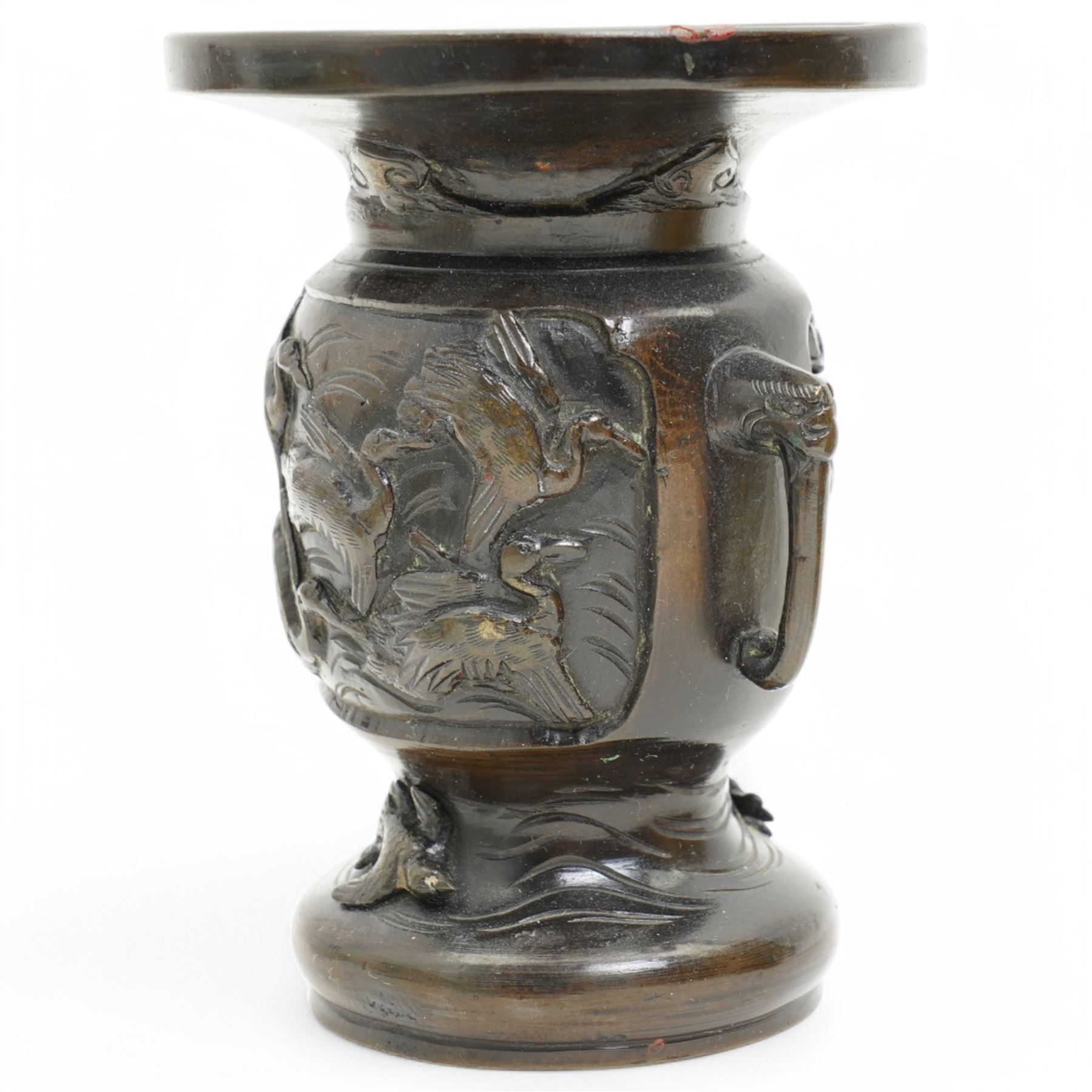 Chinese 20th century polished bronze rice pot with swing handle and raised pattern of dragons D18cm, Meiji period Japanese bronze two handled vase H13cm and a Chinese porcelain bowl from the Tek Sing cargo D15cm (3)
