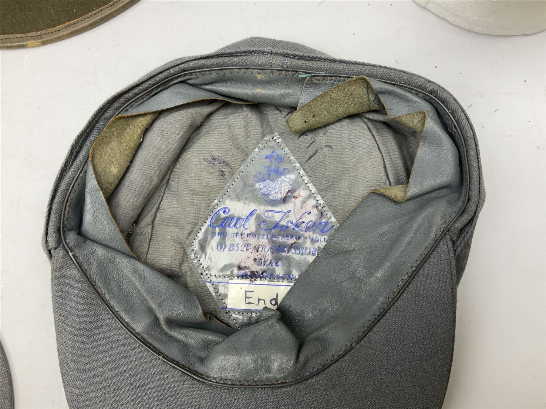 Five reproduction German WW2 hats comprising Wehrmacht olive tropical helmet, Heer officer's peaked cap, two M43 caps and Field side cap (5)