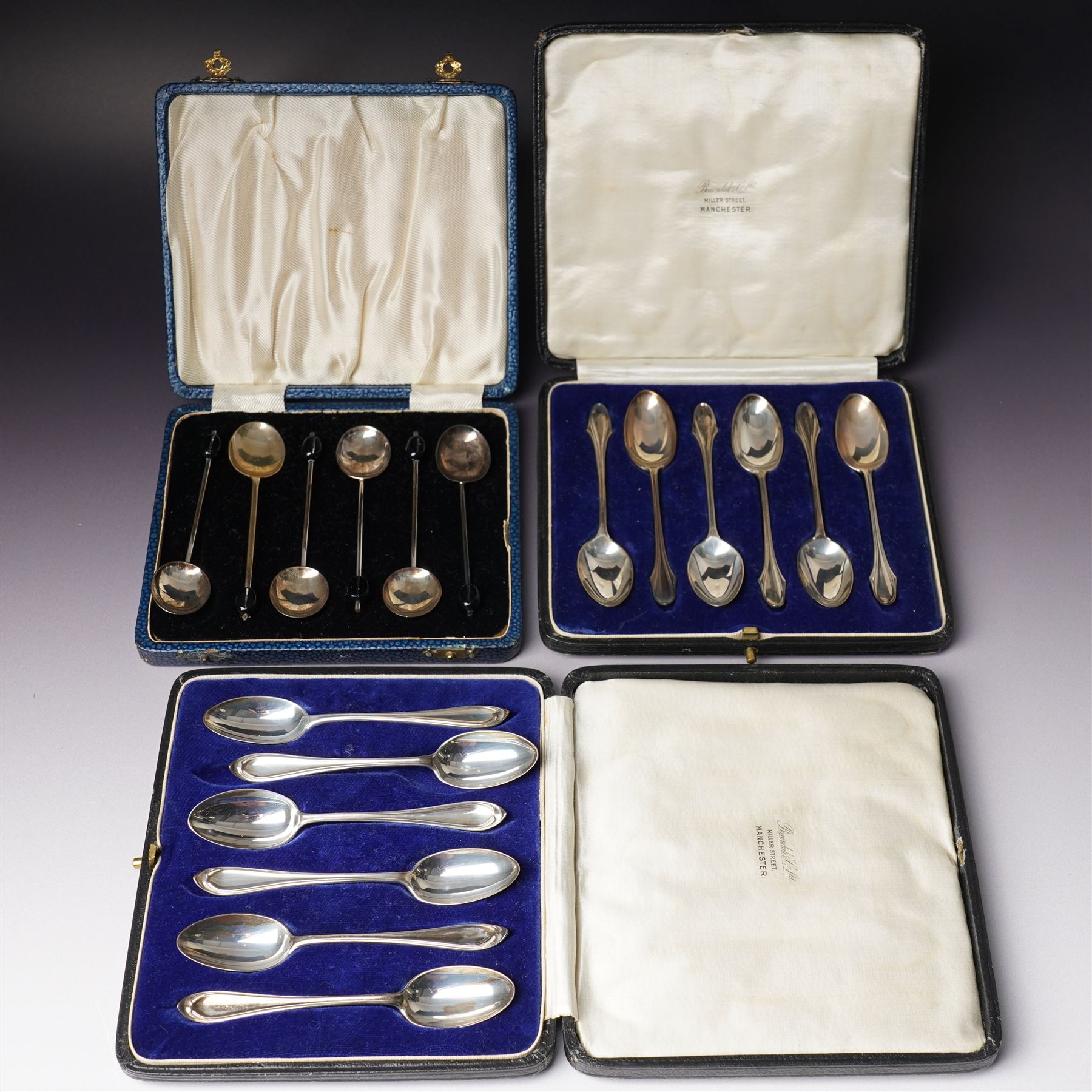 Set of six silver coffee spoons with shaped terminals, cased London 1924, another set of similar spoons London 1924 cased and a set of six silver bead knop spoons Birmingham 1936, cased