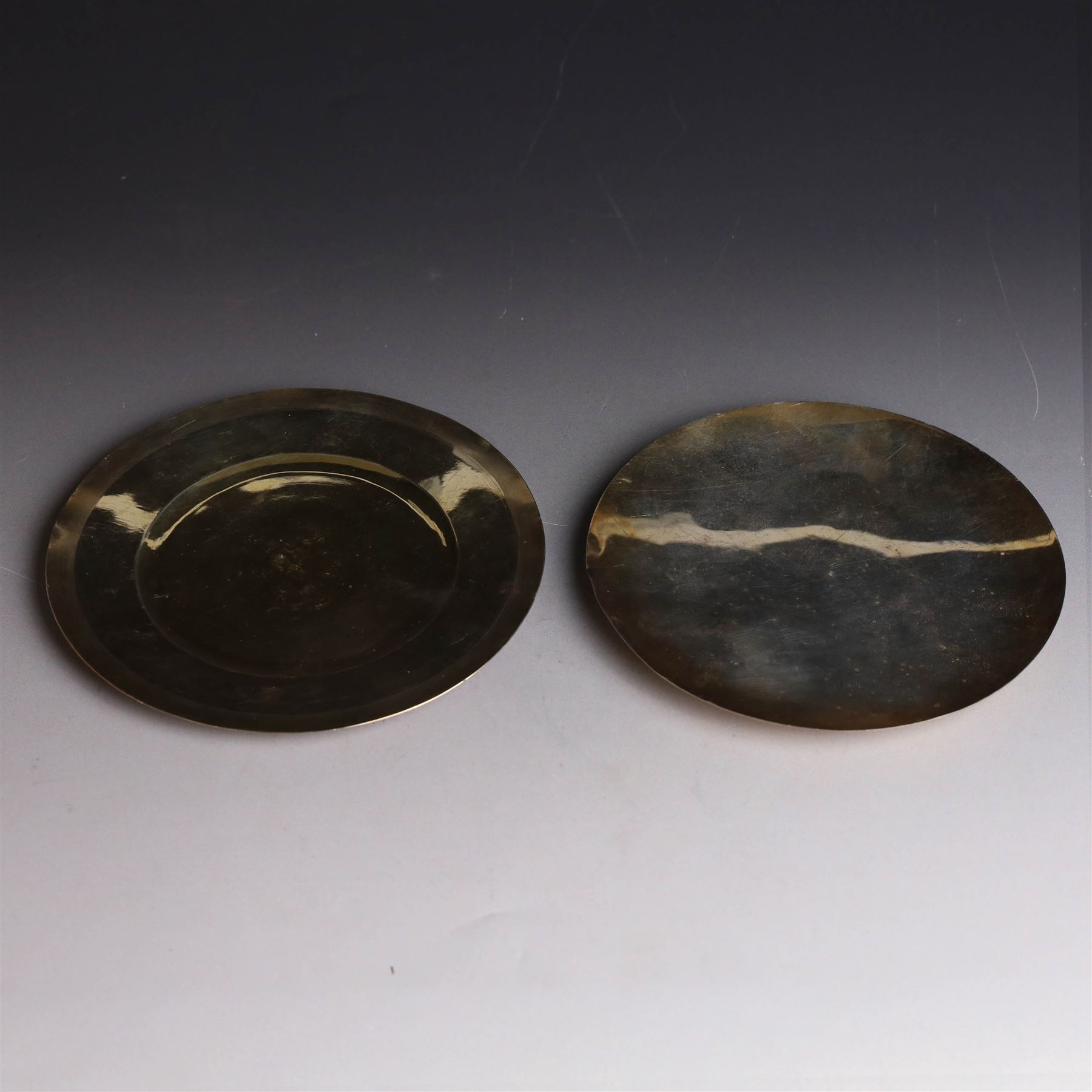 Two silver-gilt patens, comprising French silver example, of typical flatted circular form, engraved IHS to underside, with Minerva's head mark to one side and a 1960s example of similar form engraved IHS to underside, hallmarked Pepper & Hope Ltd, Birmingham 1967, largest D12.5cm