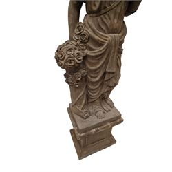 Hand carved stone Neoclassical figure of the Roman goddess Flora, her hair pinned with roses, draped in a toga, holding a basket of flowers in her right hand, raised on a stepped square plinth base 