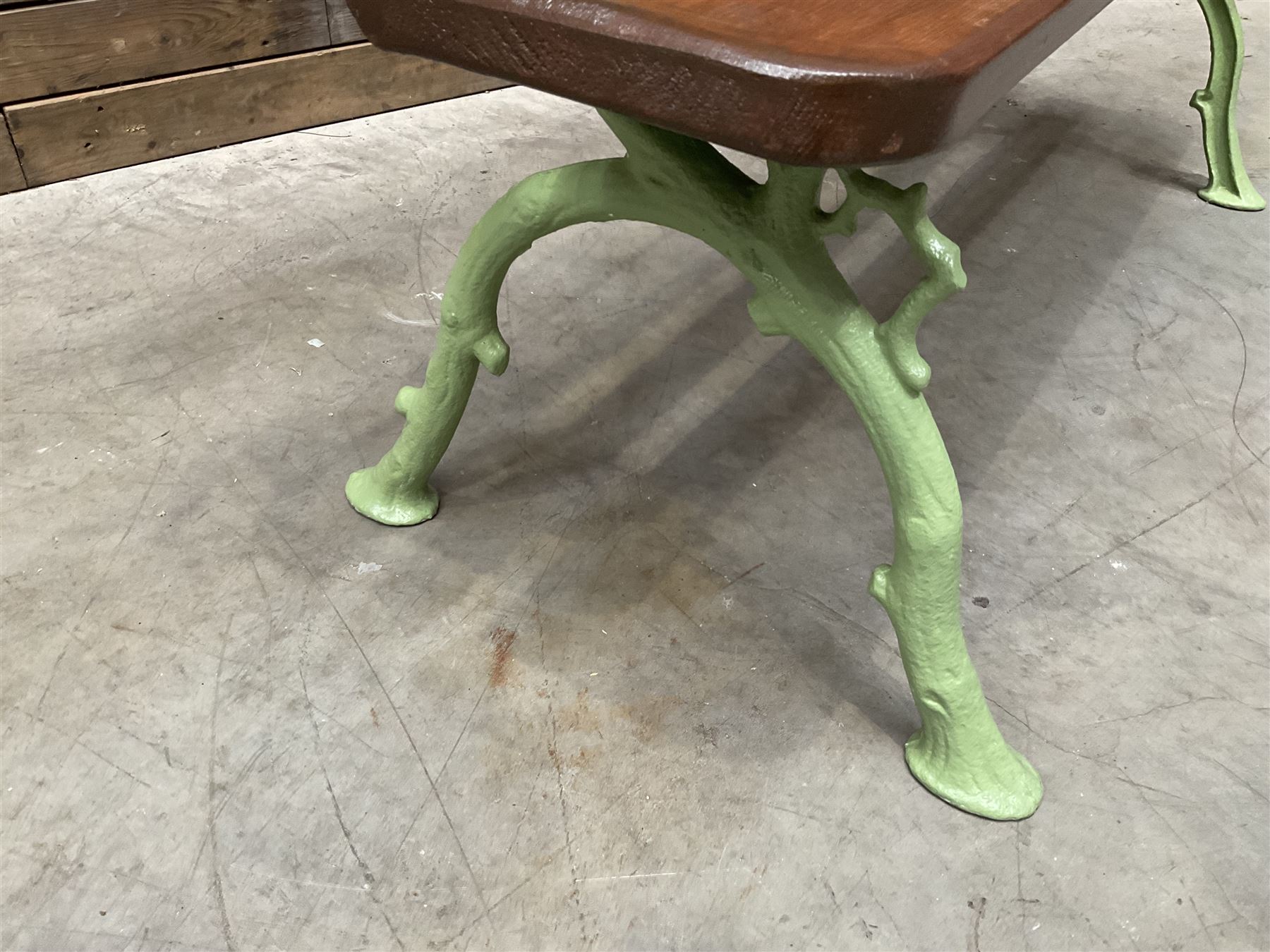 Cast iron and wood slate bench painted in green