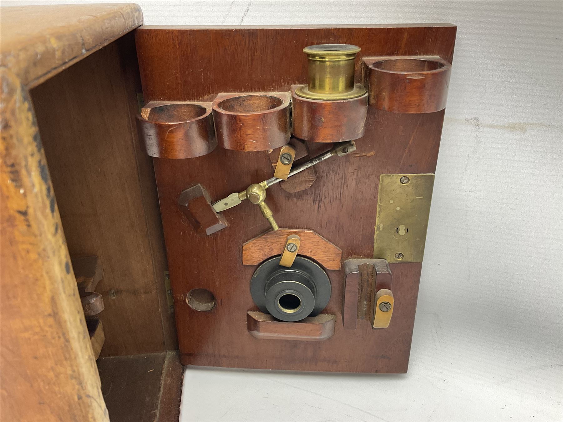 Mid 19th century brass monocular microscope by Andrew Ross, London No.180, with pitchfork base, rack and pinion focusing, revolving bed and swivelling barrel, with accessories, housed in a mahogany case with recessed carry handle and lockable doors