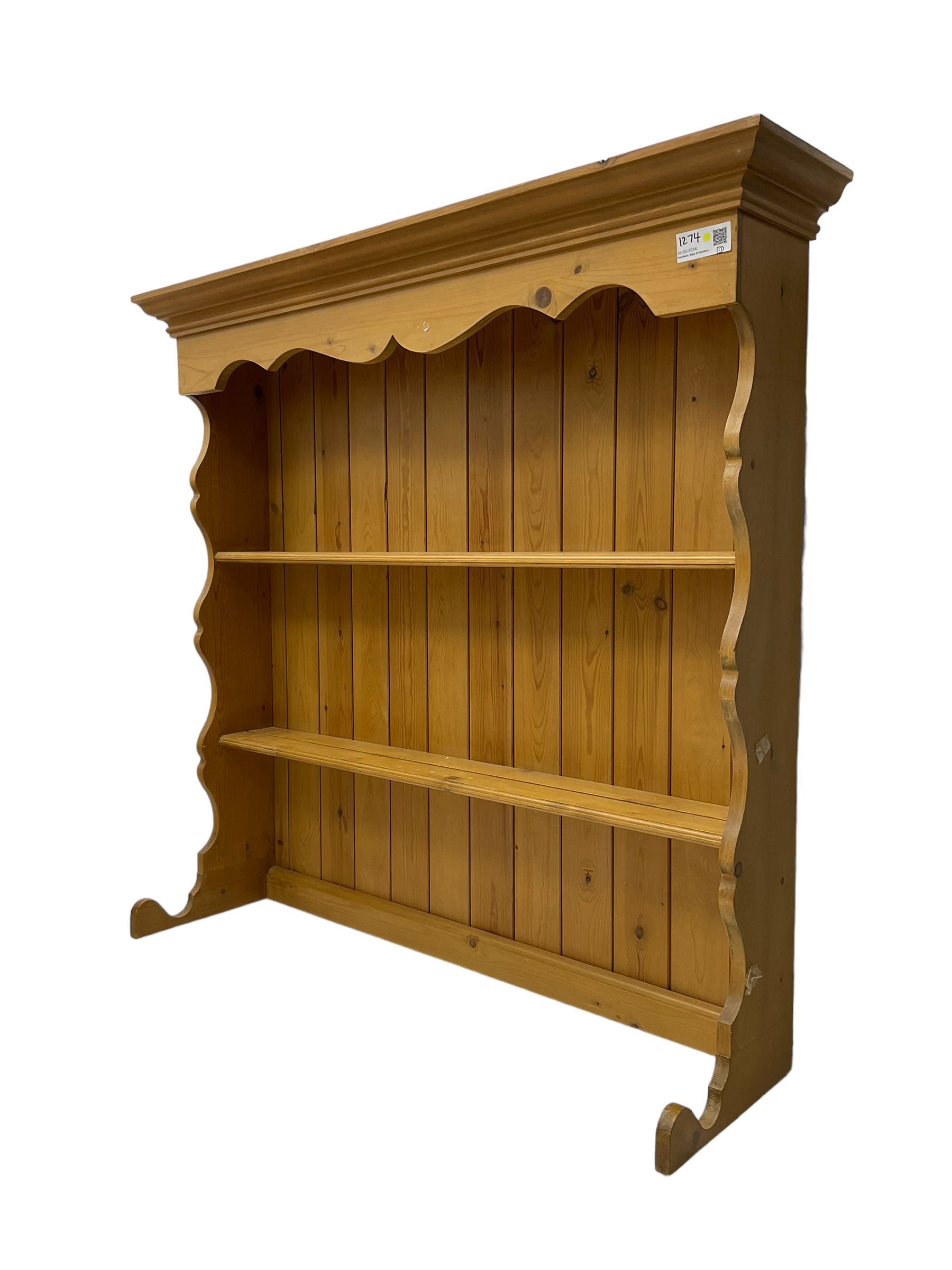 Pine media or television cabinet, enclosed by single glazed door (W56cm, H82cm, D43cm); pine corner cupboard, three shelves over single cupboard (W76cm, H188cm); pine two-tier plate rack with shaped frieze and uprights (W113cm, H107cm)