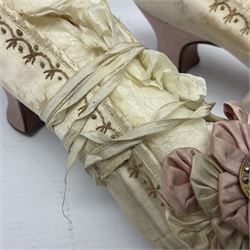 Pair of 19th century ivory silk satin ladies shoes, with rosette to the vamp, with pink silk satin heel, L23cm