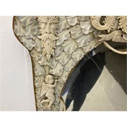 Pair 19th century French Dieppe bone and ivory wall mirrors, the oval bevelled mirror plates within rectangular frames with shaped tops, profusely decorated with ivory leaves, further detailed with carved bone armorial type crest inscribed 'SGOTORVM', putti, fish and mask heads, H81cm W48cm