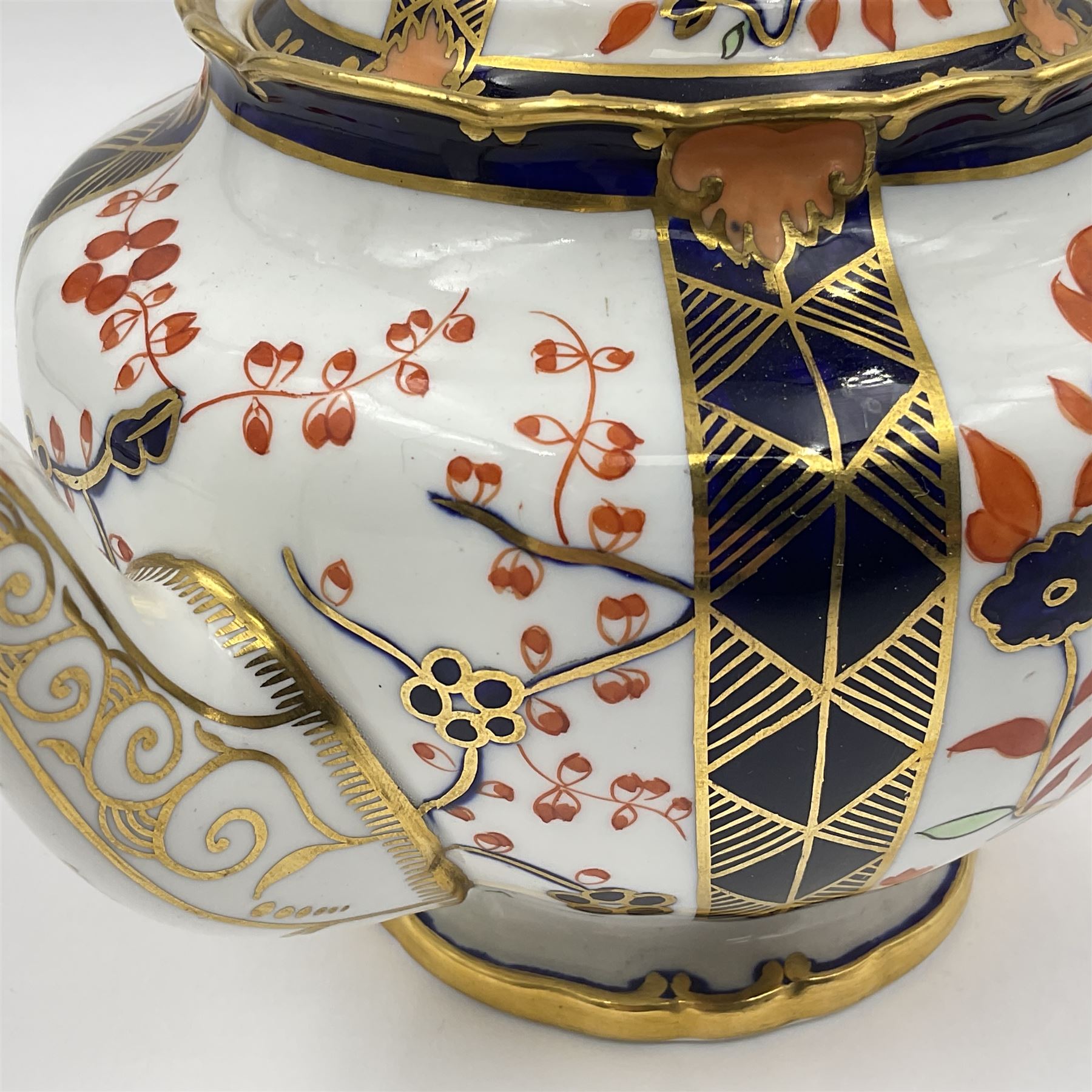 Early 20th century Royal Crown Derby teapot, decorated in a variant of the Imari pattern with blue and red prunus blossoms, with printed mark beneath including illustration date code for 1927, H14cm
