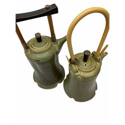 Two Chinese style Studio Pottery kettles, with merging green glaze and handles, each marked beneath, not including handle largest H18cm, together with a Studio Pottery jar, of domed form with twist handle to the slender cover, a turquoise and blue stoneware vase with tapering neck, a four piece rosewater sprinkler and vase set, each of bellied/baluster form, decorated with floral sprays and flower heads, and a pewter preserve pot and spoon, the body with pierced sides holding a clear glass liner.  