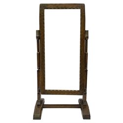 'Gnomeman' dressing table mirror, rectangular frame with bevelled plate and crenellated slip, Gothic octagonal and stepped supports, on sledge feet joined by stretcher

Provenance - This collection of early 'Gnomeman' furniture comes to us directly from the Whittaker family. The pieces were made by the vendor's father Thomas Whittaker in the 1930/40s for his own use. During this time, he lived in York and made items for himself and friends. Whittaker adopted the gnome as a signature and trademark after his move to Littlebeck, Whitby.