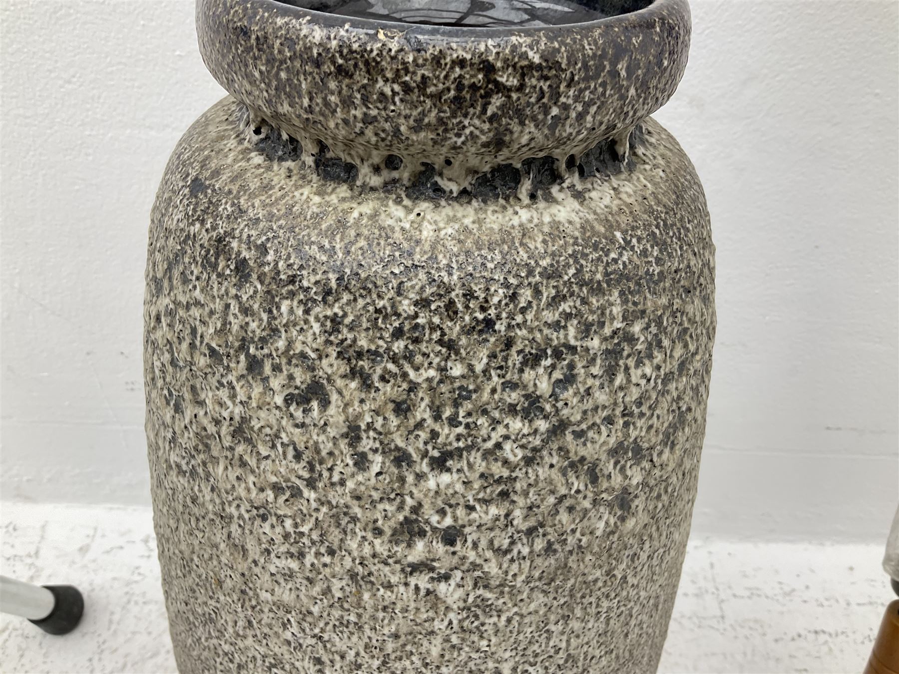 Two smooth polished ram horn handled Shepherd's crooks and a further similar example, together with various shooting sticks, walking sticks and canes, housed in a volcanic lava glaze West German style vase