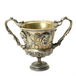 Christofle 'Tresor d'Hildesheim' facsimile gilt metal two handled cup decorated with masks, leaves etc H13cm and a bowl from the same collection with two handles and a raised pattern of leaves on a pedestal foot D19cm (2) 
