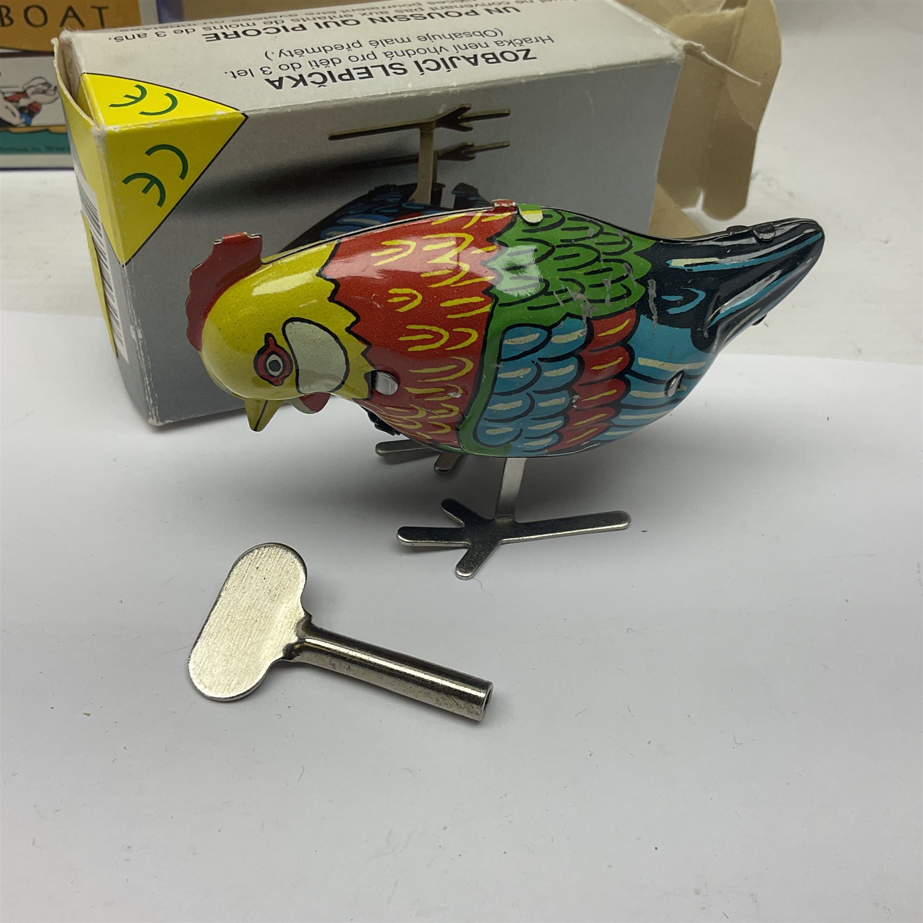 Twenty six tinplate models to include Ferris Wheel and Performing Circus Elephant, marked JW, further similar examples such as Duck on a Bike, Clown on Roller, Carousel; Popeye Tin Speedboat; Looney Tunes Wind Up Cars and Express Train; various international examples, MS107 Jumping Bambi, Pop Pop Boat, jumping frogs, pecking chickens etc; both boxed and loose