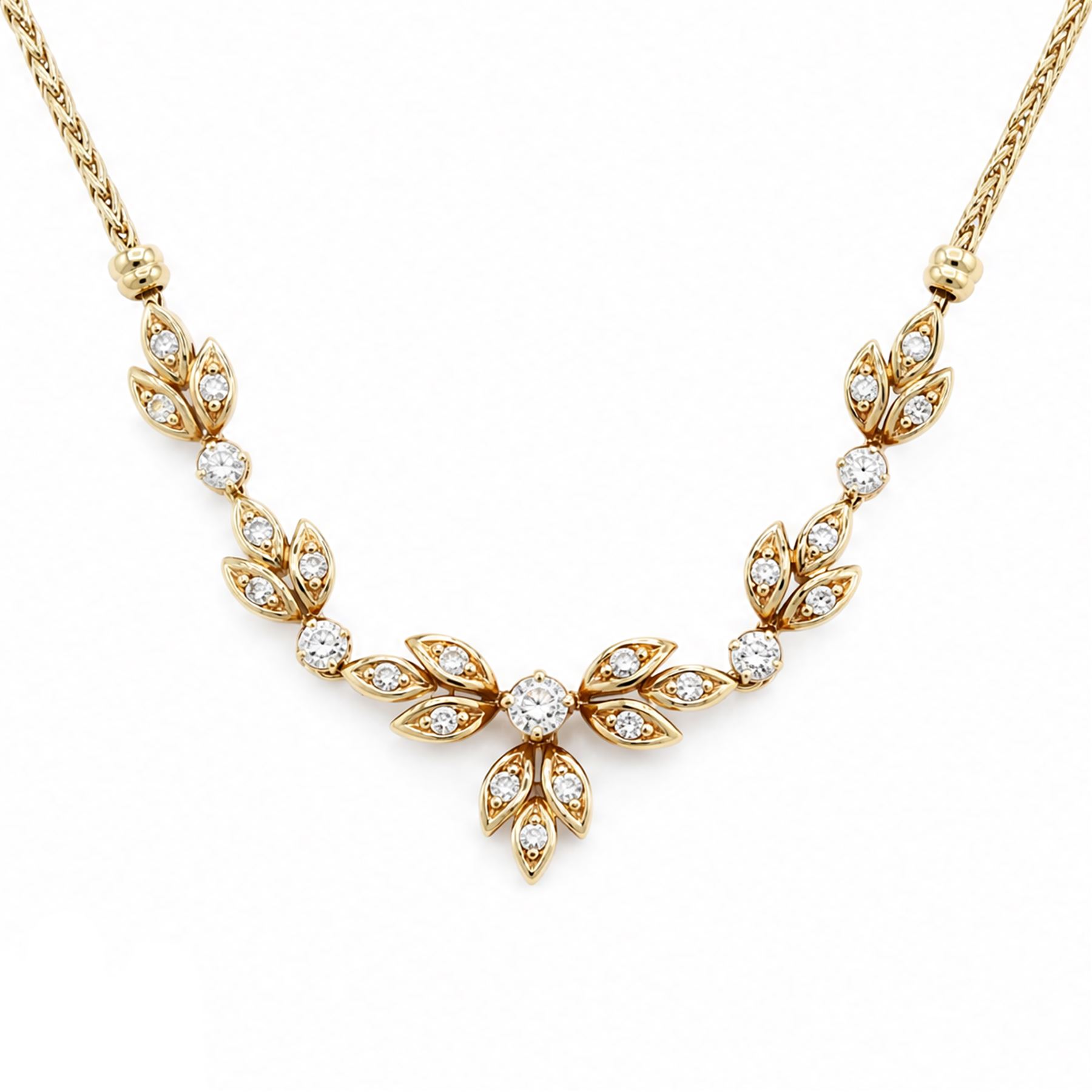 18ct gold diamond floral design necklace, five round brilliant cut diamonds, each spaced by leaf design links set with diamonds, to a Spiga link chain, Sheffield import mark 1989, total diamond weight approx 0.75 carat