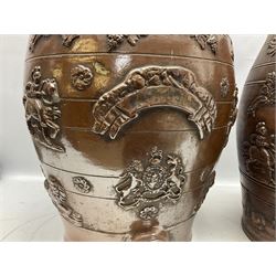 Two 19th century brown salt glazed stoneware spirit barrels, decorated in relief with the royal coat of arms, largest H58cm