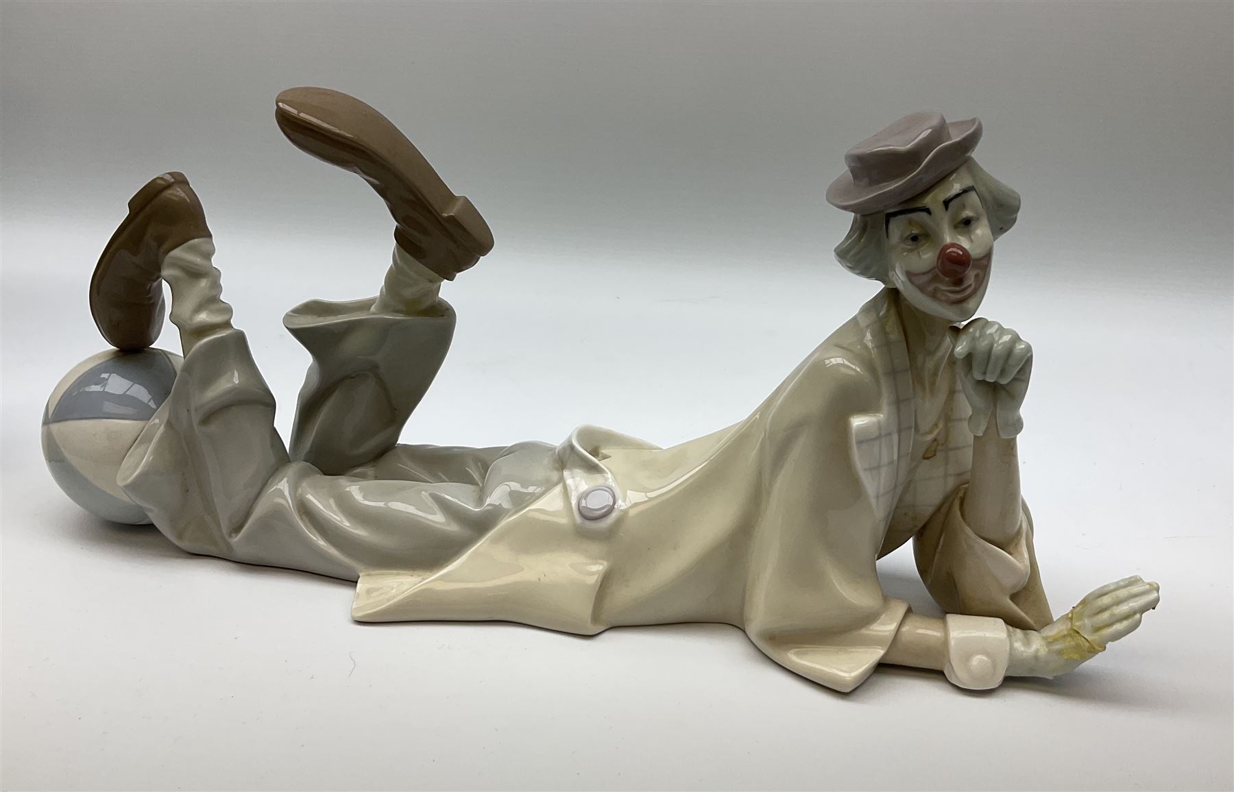 Collection of seven Lladro figures, including Seated ballerina with swan 6204, Childhood Dream 8129, Dancer 5050, reclining clown with ball alongside a selection of other figures. 