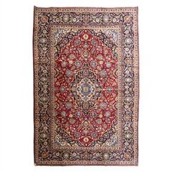 Central Persian Kashan hand-knotted rug, rich red field with a central lobbed medallion su...