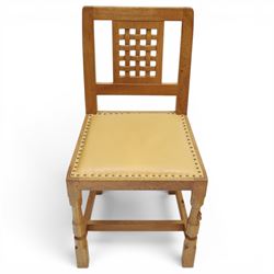 Mouseman - set of eight light oak dining chairs, each with lattice panel back and tan leather upholstered seat, raised on octagonal front legs joined by stretchers, with signature carved mouse, by the workshop of Robert Thompson, Kilburn